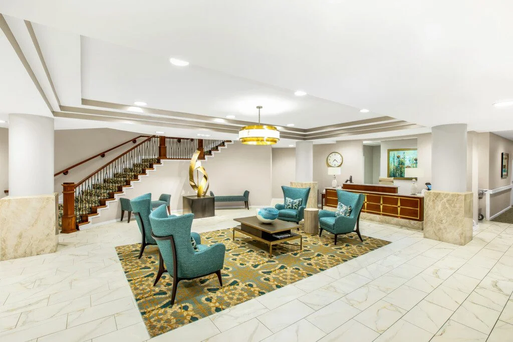 expansive lobby with seating and modern decor at Claridge Court Senior Living Community