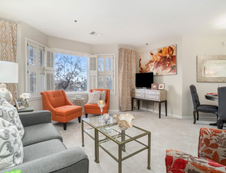 spacious living room and dining area of senior apartment at Claridge Court Senior Living Community